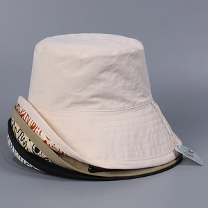 Close-up of assorted waterproof nylon sun hats with adjustable drawstrings in various colors