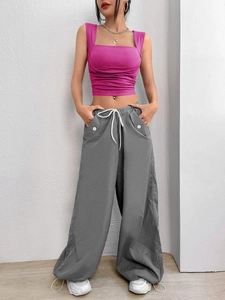 Slim fit rose pink square neck crop top paired with dark grey cargo pants