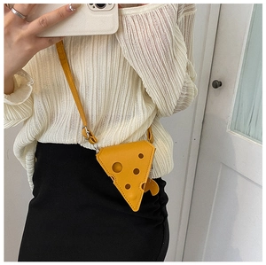 Close-up of yellow Swiss cheese shaped mini crossbody bag with creative hole cutouts
