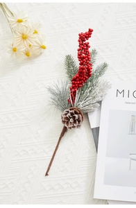 Close-up of Christmas sprig with red berries, pine cones and frosted needles