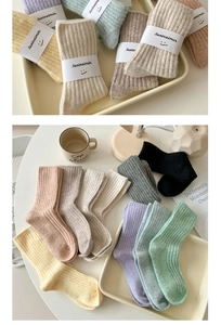 Close-up of thick ribbed knit wool socks in various warm earth tones and colors