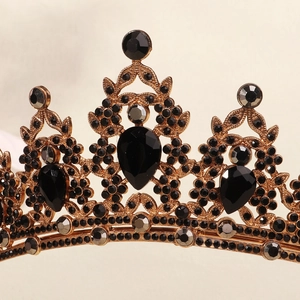 Close-up of ornate gold Halloween crown with black rhinestones for party costume