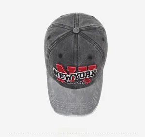Detailed close-up of vintage washed denim baseball cap with New York letter embroidery