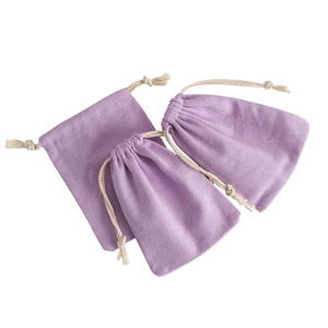 Three light purple linen drawstring pouches for jewelry storage on white background