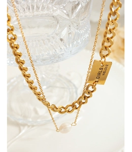 Macro shot of double-layer gold chain necklace with freshwater pearl and square pendant