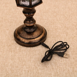 Close-up of bronze vintage lamp base showing USB power port and metallic texture