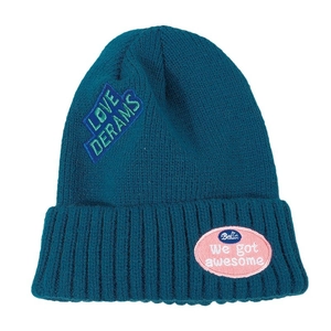 Dark teal knit beanie with pink and blue embroidered patches and ribbed turn-up cuff