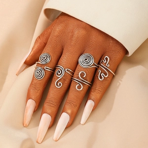 Set of four vintage silver wire wrap rings with geometric spiral and wavy designs