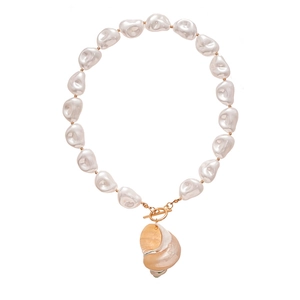 Baroque pearl necklace with seashell pendant and golden OT clasp on white background