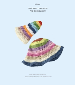Detailed view of colorful rainbow striped hand-woven straw bucket hat with textured finish