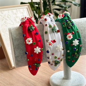 Close-up of festive Christmas headbands with rhinestone Santa and tree decorations