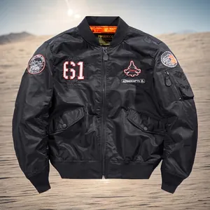 Men's black MA-1 bomber jacket with aviation patches and orange lining in a desert setting
