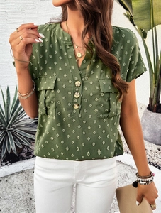 Detail of green textured short-sleeve shirt with V-neck, buttons, and front chest pockets
