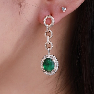 Rose gold teardrop earrings with green oval gemstone and pave-set diamond circles