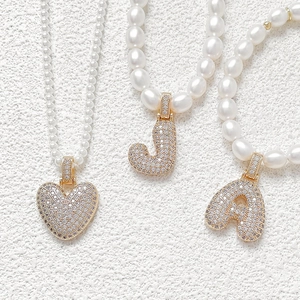 Pearls necklaces with heart and zircon initial pendants on golden metal bases