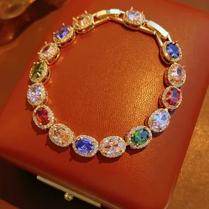 Vintage gold bracelet with oval colorful gemstones and sparkling zircon accents