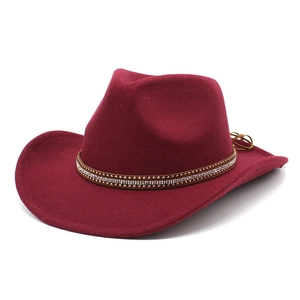 Detailed close-up of wine red western cowboy felt hat with rhinestone and stud band