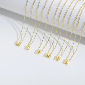 Minimalist gold plated capital letter pendant necklace on delicate cross chain for women