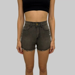 Close-up of high waist gray denim shorts with frayed raw hem and distressed details