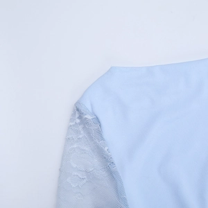 Détail de la robe bleu clair montrant la manche en dentelle et la texture du tissu