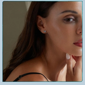 Close-up of small blue butterfly stud earring in S925 sterling silver on model ear