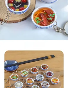 Macro shot of miniature blue and white porcelain bowl pendants with diverse food models