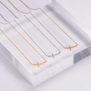 Three-color minimalist cross smile necklaces in gold, silver, and rose gold finishes