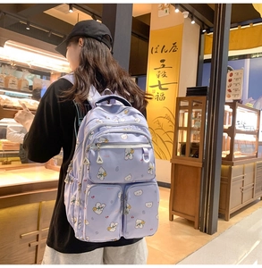 Close-up of lavender student backpack with cute bear patterns and multi-pocket design
