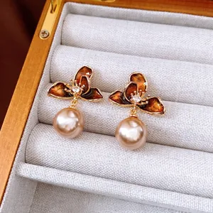 Elegant gold-plated flower earrings with pearl pendants and crystal accents