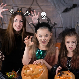 Halloween headband set featuring bats and skulls worn by models in festive setting