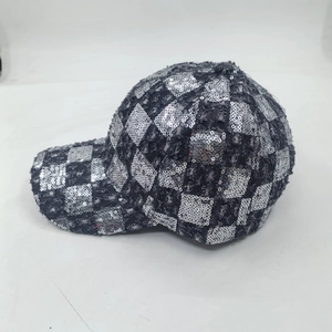 Outdoor winter baseball cap featuring silver sequins in a checkerboard pattern on dark fabric