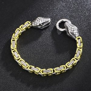 Detail of snake head clasp and two-tone gold and silver stainless steel chain bracelet