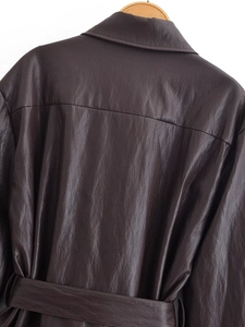Detail view showing back texture of deep brown faux leather coat with belted waist