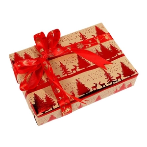 Close-up of vintage kraft Christmas wrapping paper with red foil reindeer patterns