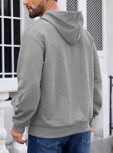 Detailed back view of men's grey hooded sweatshirt featuring unique wavy jacquard texture