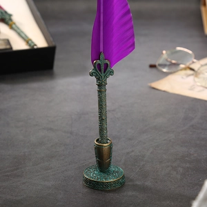 Detailed close-up of a vintage purple feather quill pen in an ornate bronze metal stand