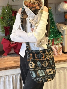 Winter plush bucket bag with colorful geometric patterns in a cozy holiday setting
