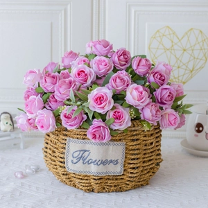Pink silk roses in a woven basket with a Flowers tag for home and wedding decor