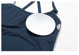 Detail showing removable pads and mesh pocket of the dark blue fitness sports bra