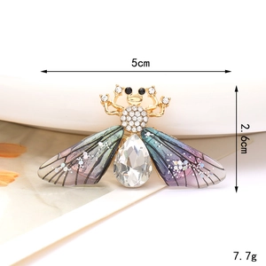 Golden bee brooch with white rhinestones and purple gradient wings on white background
