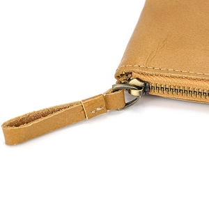 Detailed close-up of premium leather coin purse featuring durable metal zipper and neat stitching