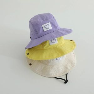 Close-up of heart patches and fabric texture on quick-dry kids bucket hats with straps