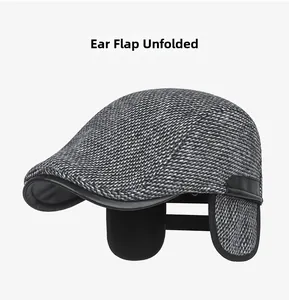 Detail view of winter plaid wool flat cap with desplegable fleece-lined earflaps and leather trim
