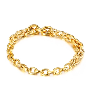 Macro detail of golden dragon scale and cable chain bracelet with lobster clasp