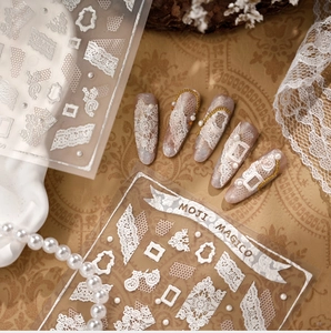 Detailed 3D embossed white lace nail stickers with elegant pearl and floral patterns