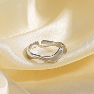 Minimalist silver irregular wave ring with adjustable open band on silk fabric