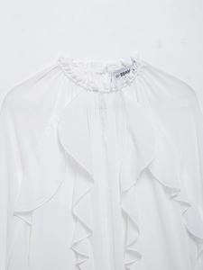 Close-up of elegant ruffle stand collar and lace details on white chiffon blouse