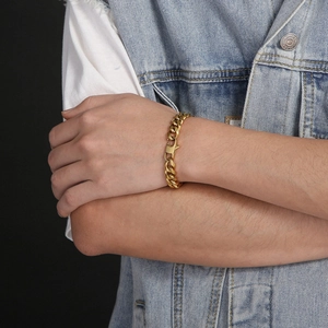 Classic gold stainless steel Cuban link bracelet for men and women on a wrist