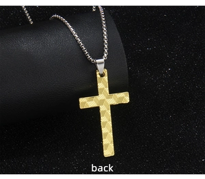 Macro view of the gold cross pendant back side featuring detailed 3D grid texture design