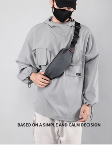 Close-up of minimalist grey waterproof chest bag with wide nylon strap and buckle detail